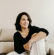 woman in black long sleeve shirt sitting on white couch